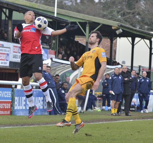 Rising High: Gavin McCallum, watched by Steve Thompson and Garry Hill, gave Woking late hope against Newport (Photo courtesy of David Holmes)