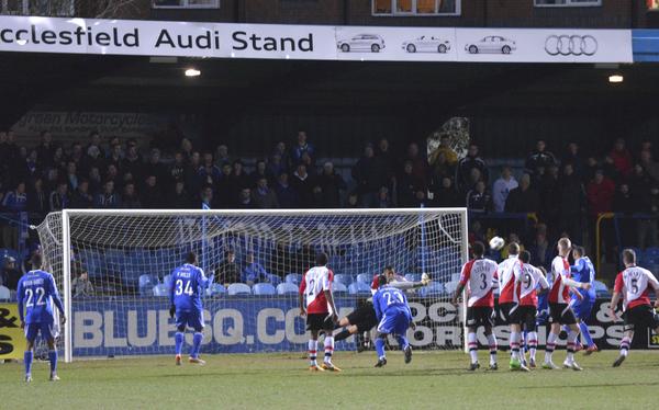 Saving Grace: Woking stopper Seb Brown saves the day at the Moss Rose (Photo courtesy of David Holmes)